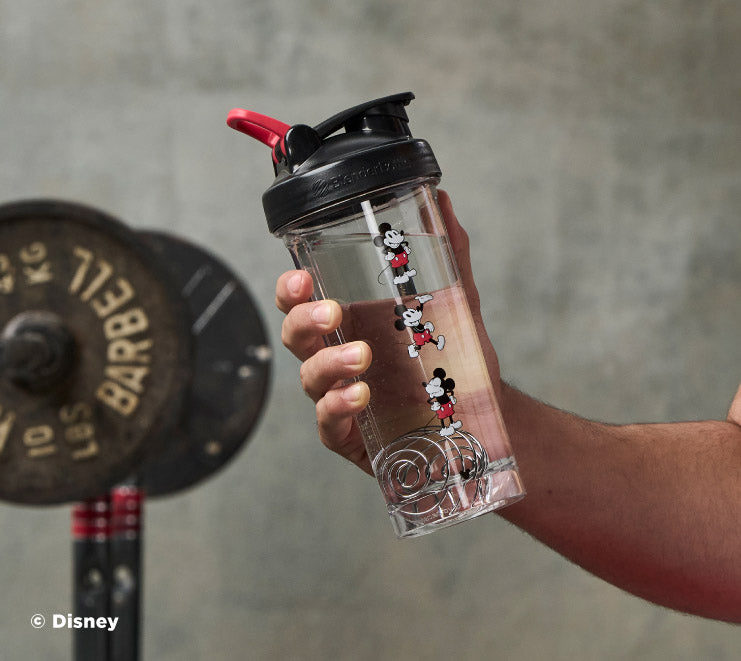 pro-series-y6 Mickey_Mouse_Protein_Shaker_Bottle_Being_Held_In_the_Gym.jpg
